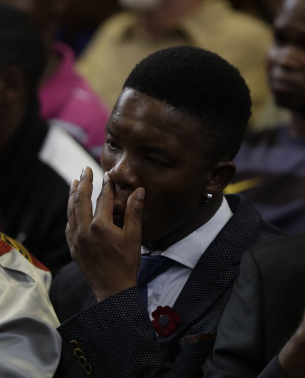Victor Rethabile Mlotshwa, who was forced into a coffin, sits inside the Magistrates Court in Middelburg, Friday, Oct. 27, 2017.  Two white men, Theo Jackson and Willem Oosthuizen, were each sentenced Friday to more than a decade in prison for forcing Mlotshwa into a coffin and threatening to set him on fire.  AP Photo/Thema Hadebe)
