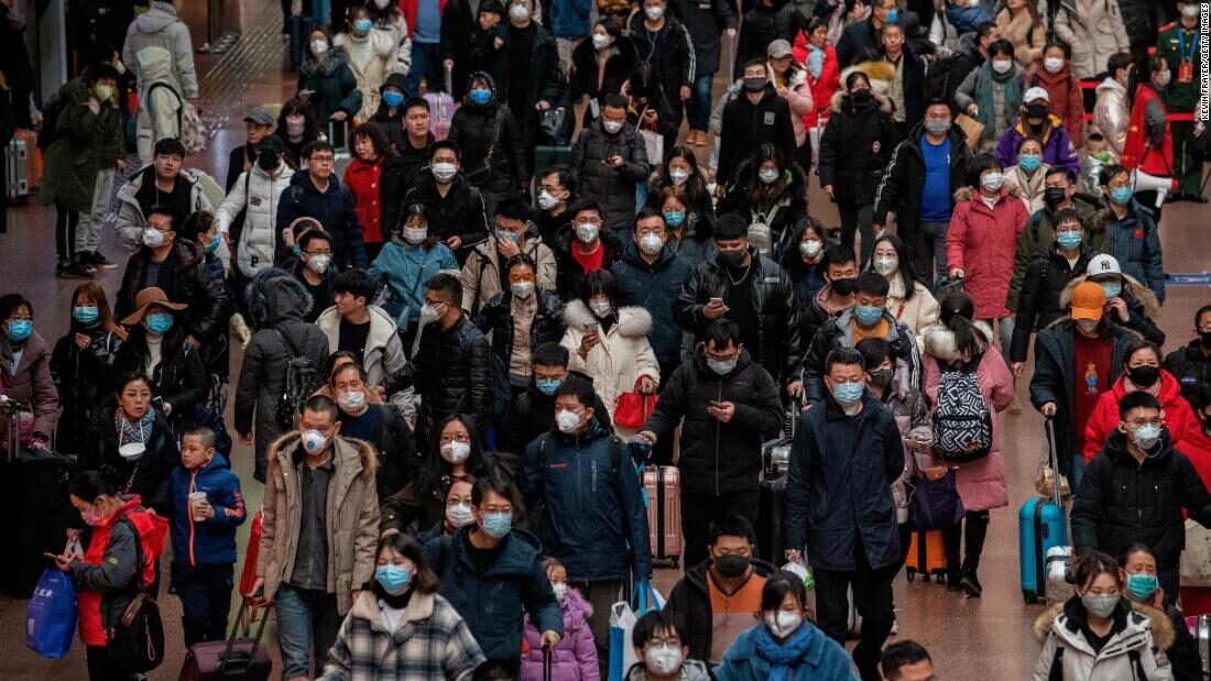 Chinese Travelers Wear Mask to Protect Against Virus