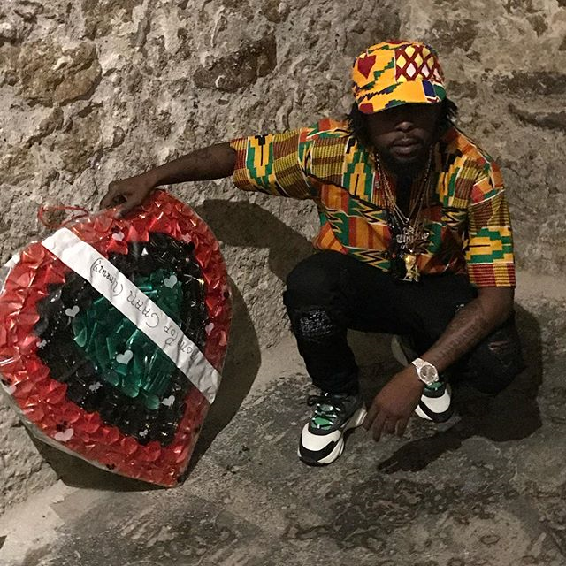 Dancehall artist #Popcaan pays respect to his ancestors by laying a wreath.