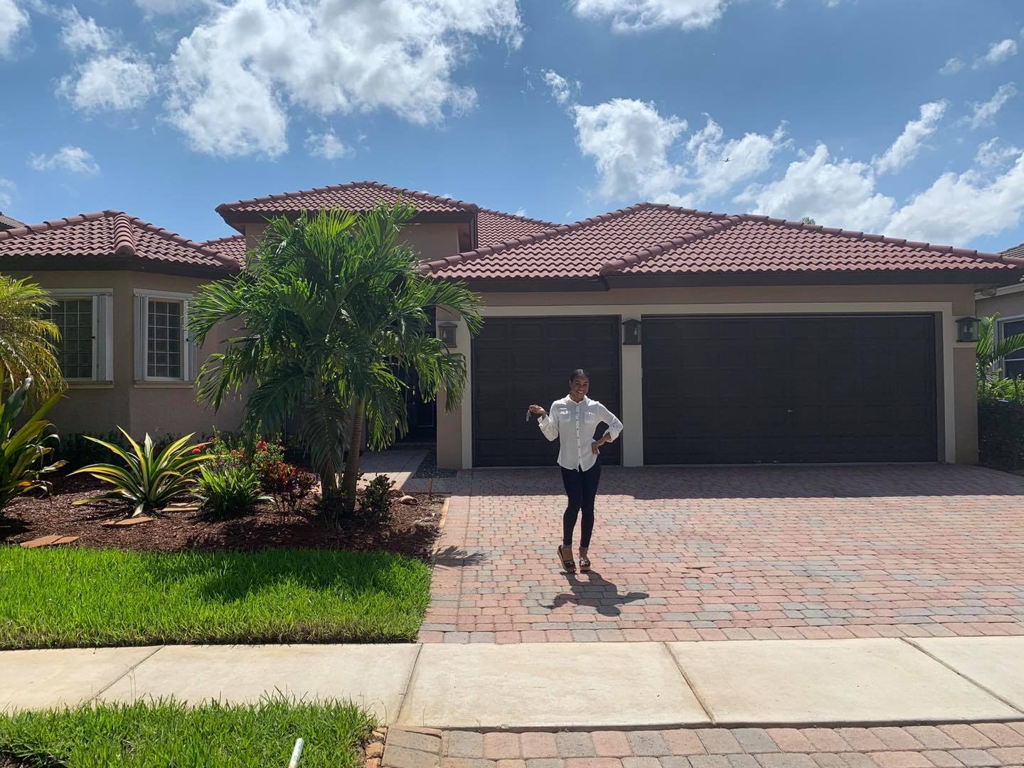 Briana Williams in front of her new home in Florida