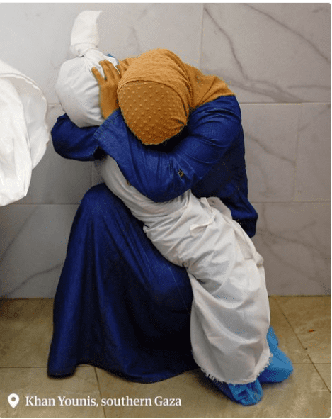 GAZA WOMAN CRADLE HER DEAD CHILD